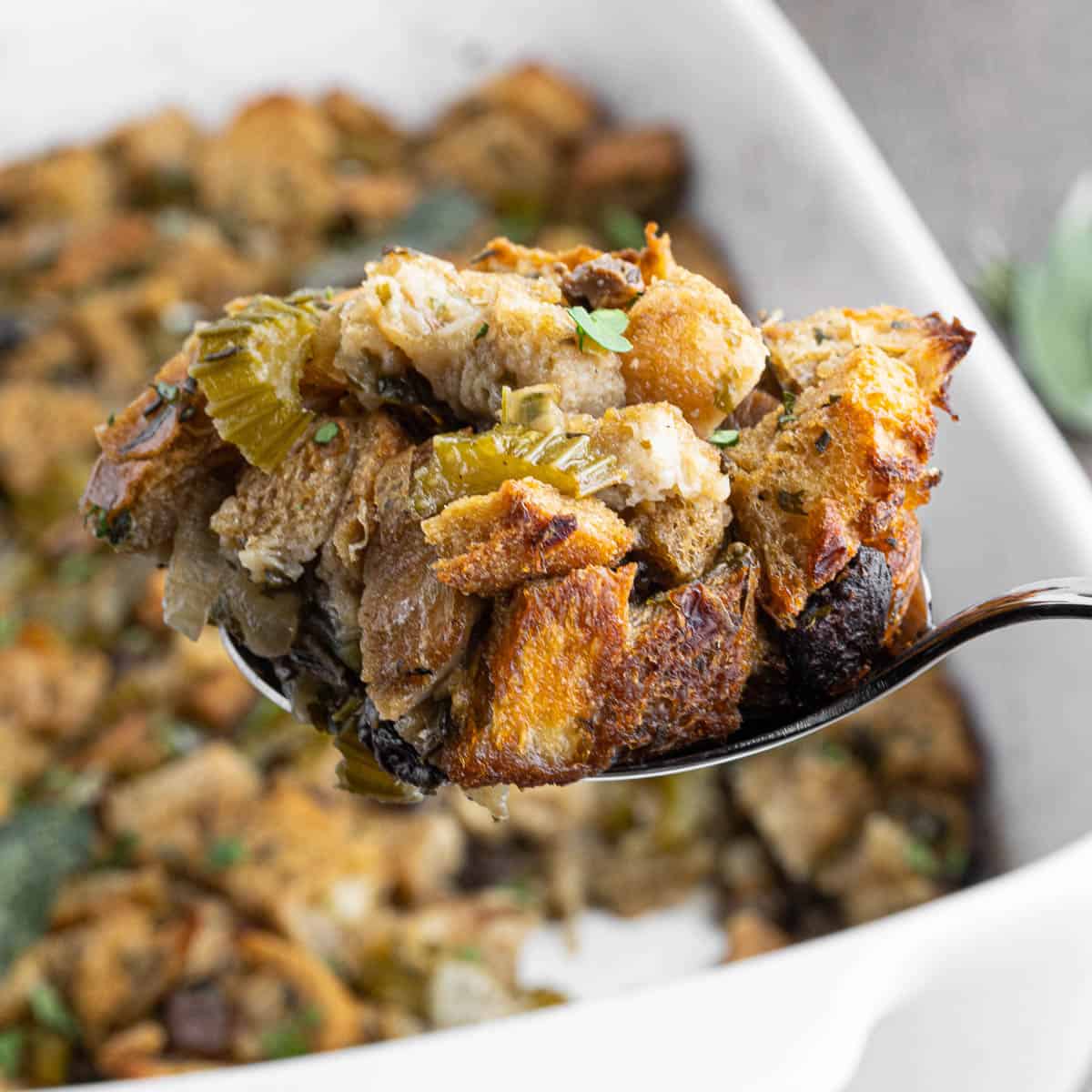 Spoonful of homemade thanksgiving wild mushroom stuffing.