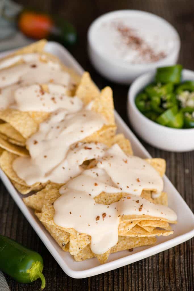 platter of nachos with homemade cheddar cheese sauce