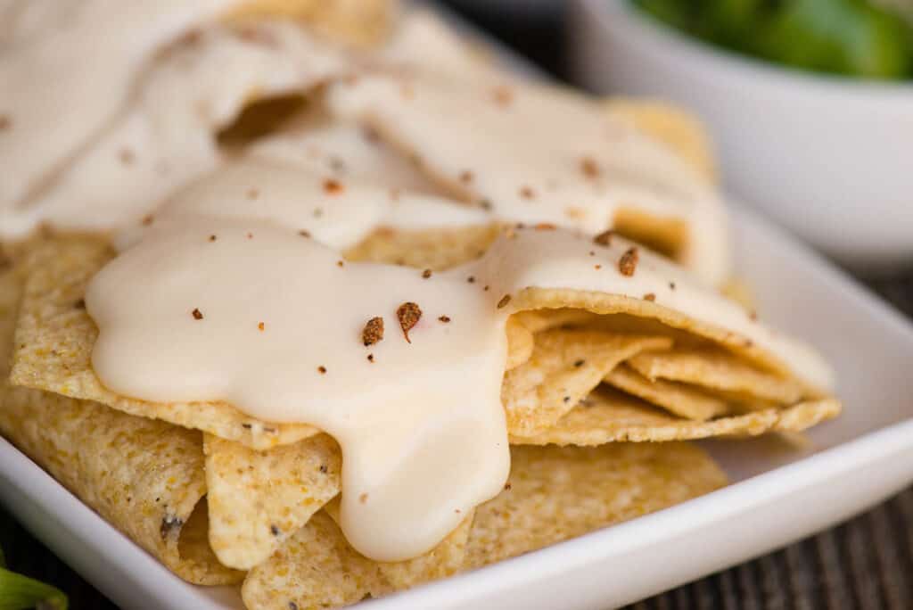 close up of Homemade Nacho Cheese sauce on chips