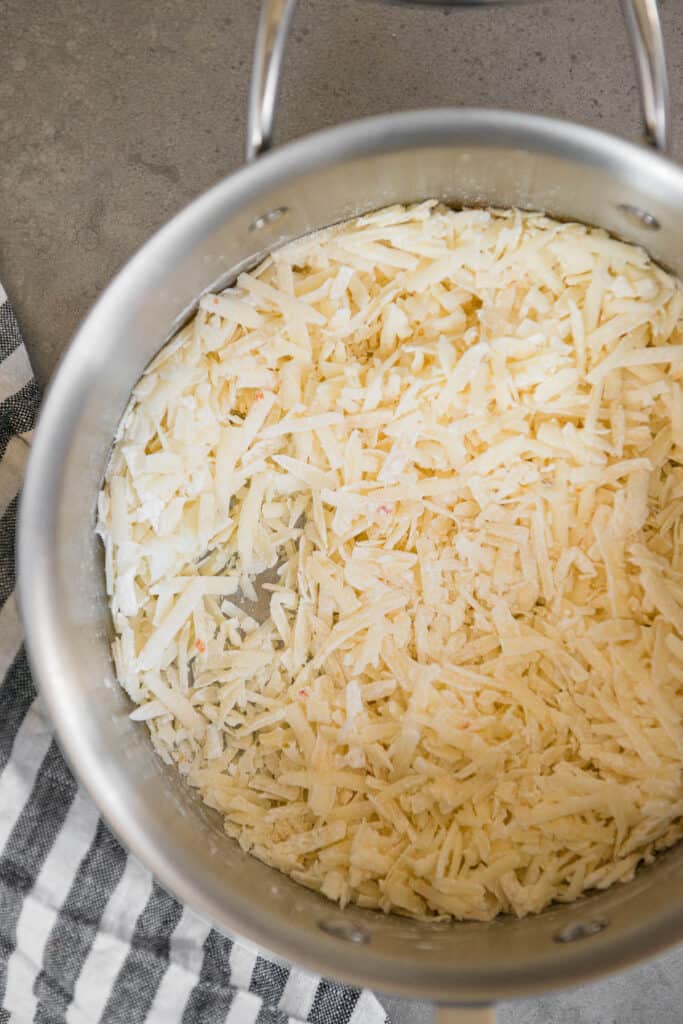 grated cheese in saucepan