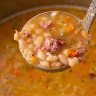 ladle full of homemade navy bean soup.