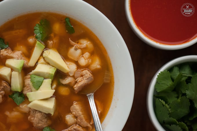 Authentic posole recipe topped with avocado