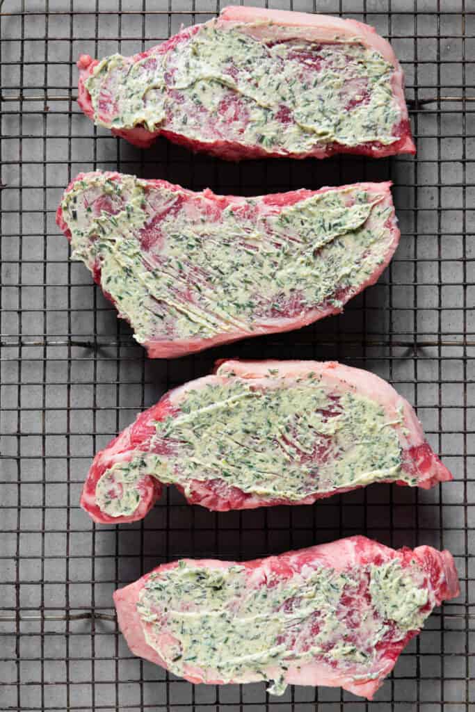 New York Steaks covered in compound butter