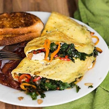 Start your morning with a healthy protein and vitamin packed breakfast. This tasty 3-egg Gorgonzola Veggie Omelet is packed with kale, peppers, and onion.