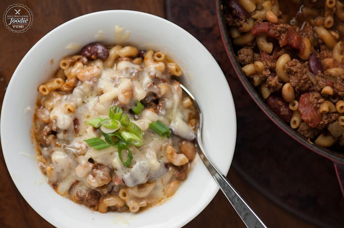 A bowl of Chili mac with elbow macaroni topped with melted cheese