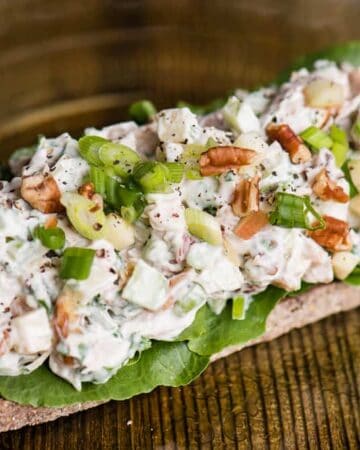 Open-faced Chicken Salad Sandwich makes for a delicious lunch! This Chicken Salad recipe comes together in minutes with cooked chicken, mayo, tart apple, crisp celery, and pecans for that extra crunch. Served open-faced on a single piece of bread gives you the same satisfaction of a sandwich with fewer carbs!