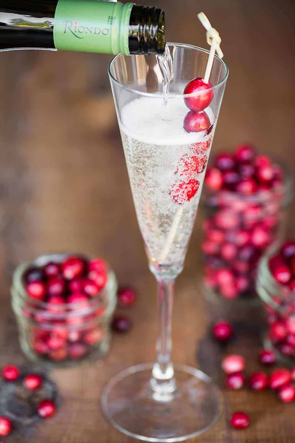 Orange Cranberry Prosecco is an easy single serving winter cocktail made from sweetened tart cranberry juice, orange liqueur, and Riondo Prosecco.