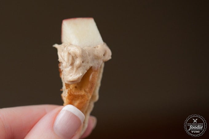 piece of apple with peanut butter fruit dip