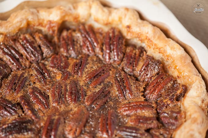 A close up of pumpkin pecan pie