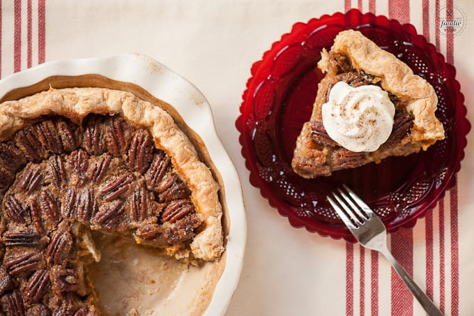 A plate of food with a slice of pecan pie