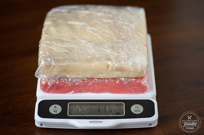 white and red sugar cookie dough on kitchen scale