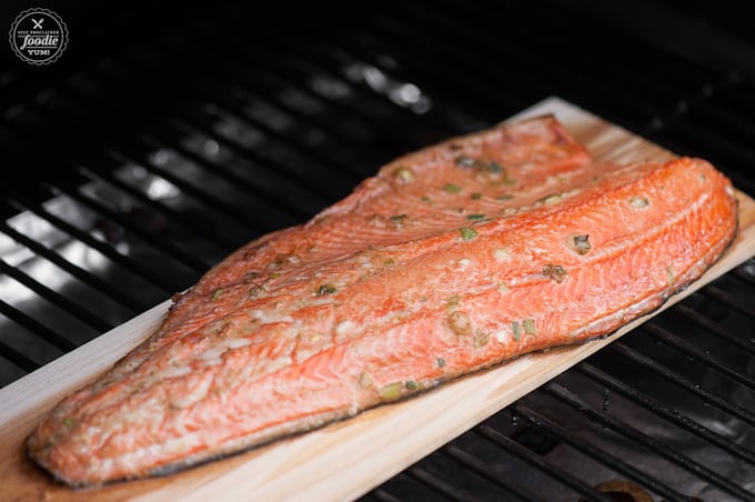 grilled salmon on a plank in an oven