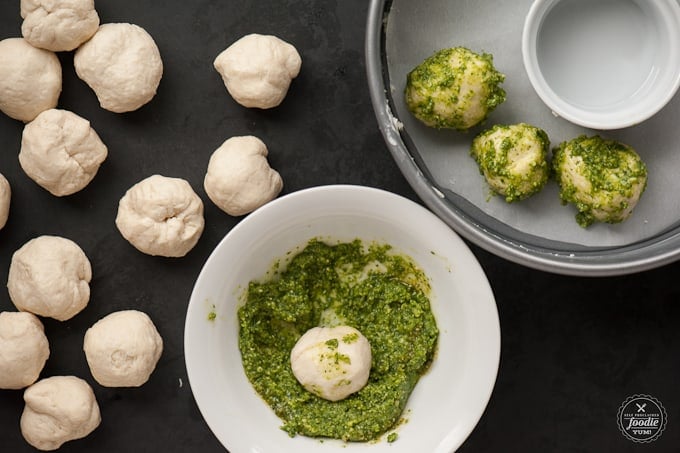 cheese filled biscuit dough balls rolled in pesto sauce