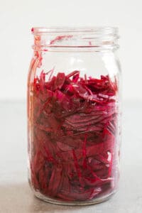 mason jar with thinly sliced beets
