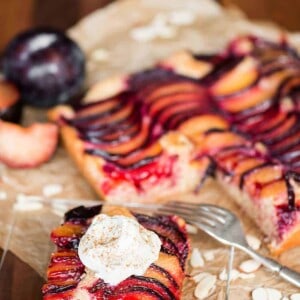 plum almond cake topped with whipped cream