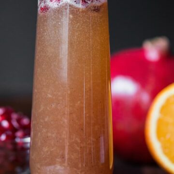 A close up of a glass of pomegranate mimosa