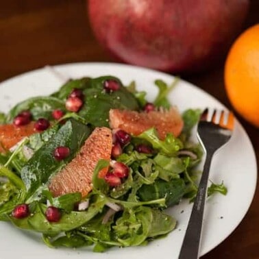 If you're looking for the perfect healthy winter side salad, this Pomegranate Orange Arugula Spinach Salad with a homemade vinaigrette is full of flavor.