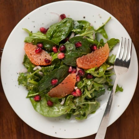 If you're looking for the perfect healthy winter side salad, this Pomegranate Orange Arugula Spinach Salad with a homemade vinaigrette is full of flavor.