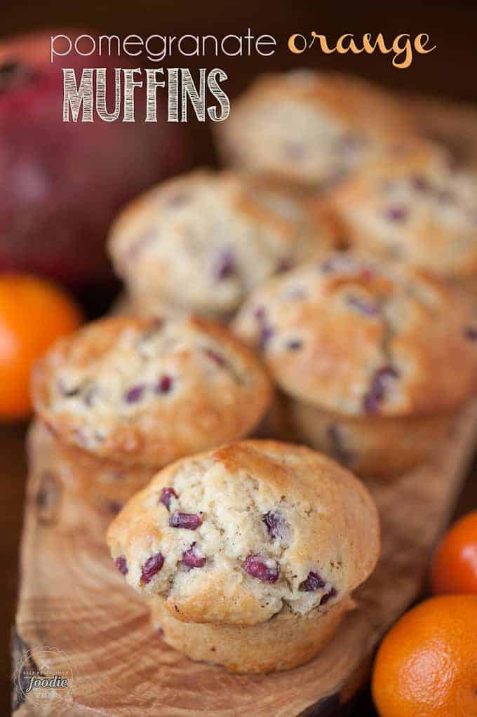 homemade buttermilk muffins with orange and pomegranate on wood platter