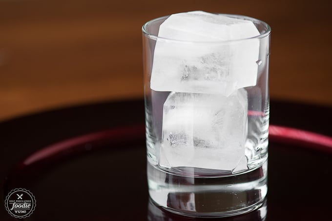 a glass with two large ice cubes