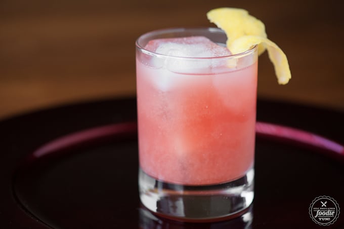 A glass of Pomegranate whiskey Sour