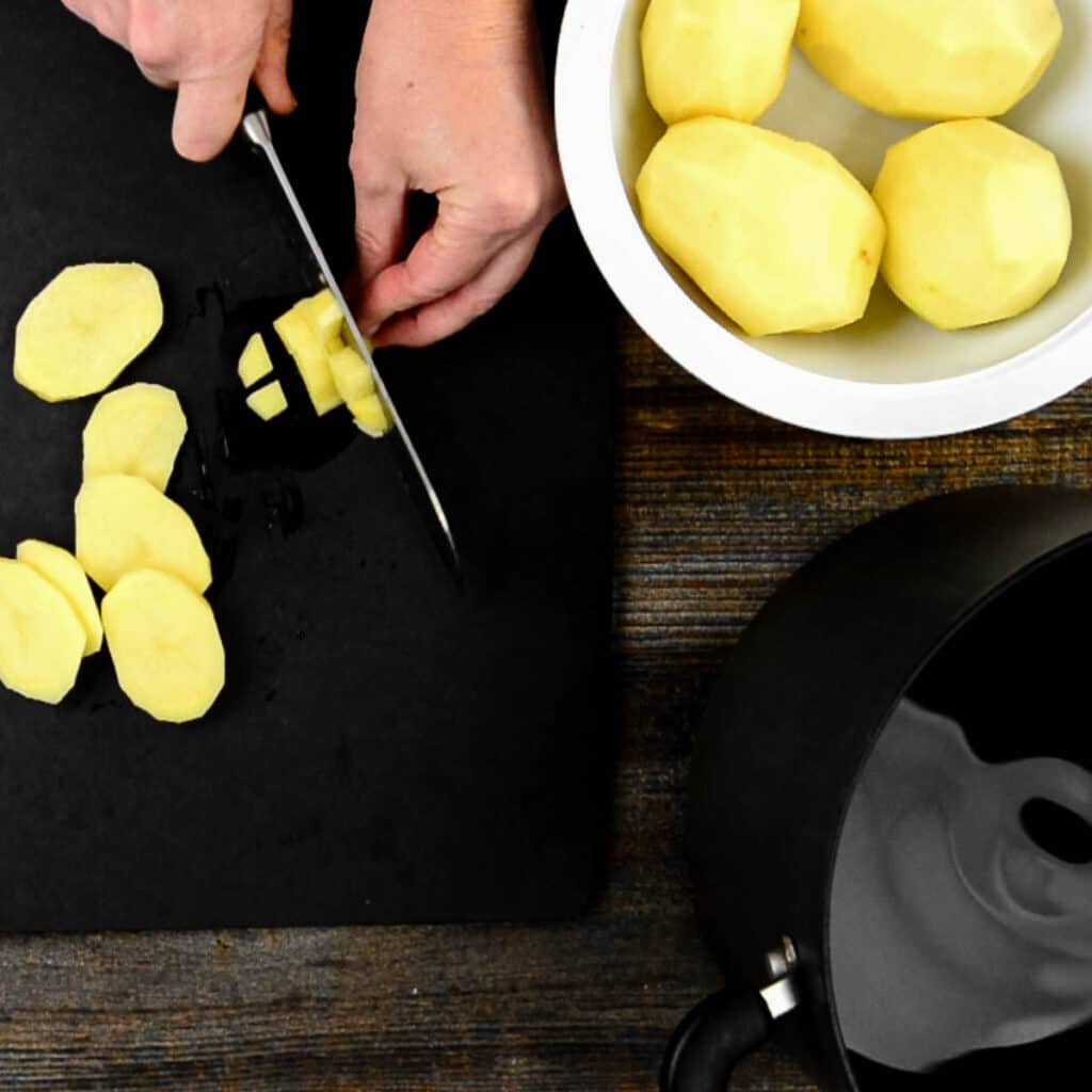 chopping peeled potatoes