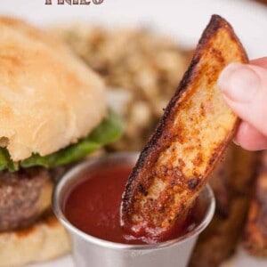 a potato wedge fry dipped in ketchup