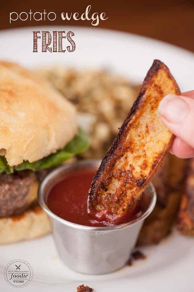 a potato wedge fry dipped in ketchup