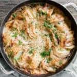 thinly sliced cheesy potatoes au gratin in round Dutch oven.