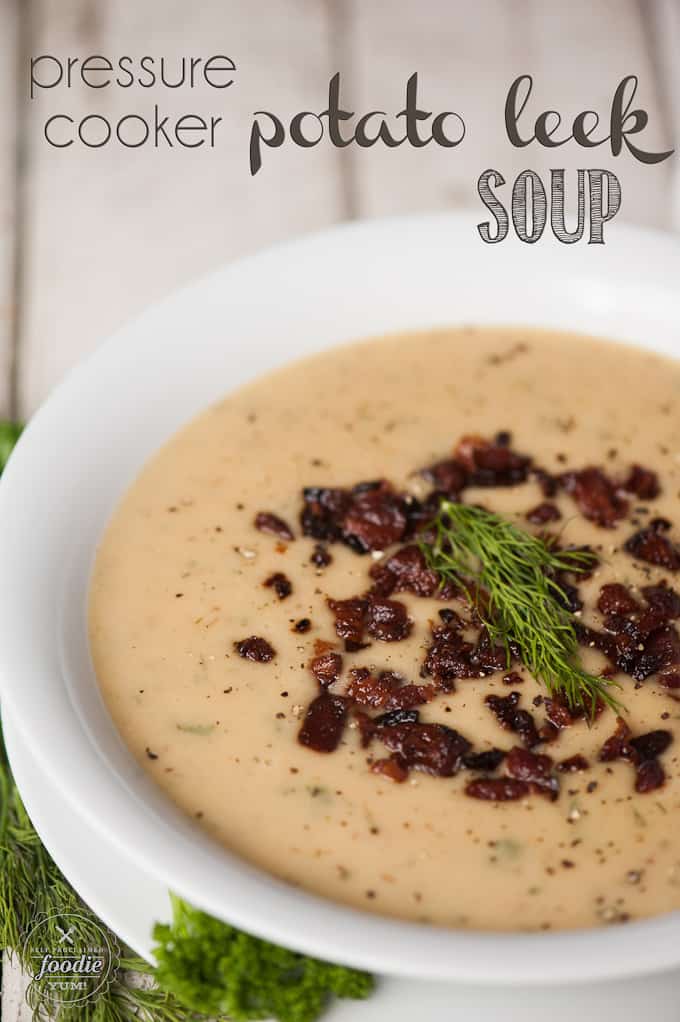 A bowl of potato leek soup topped with crisp bacon