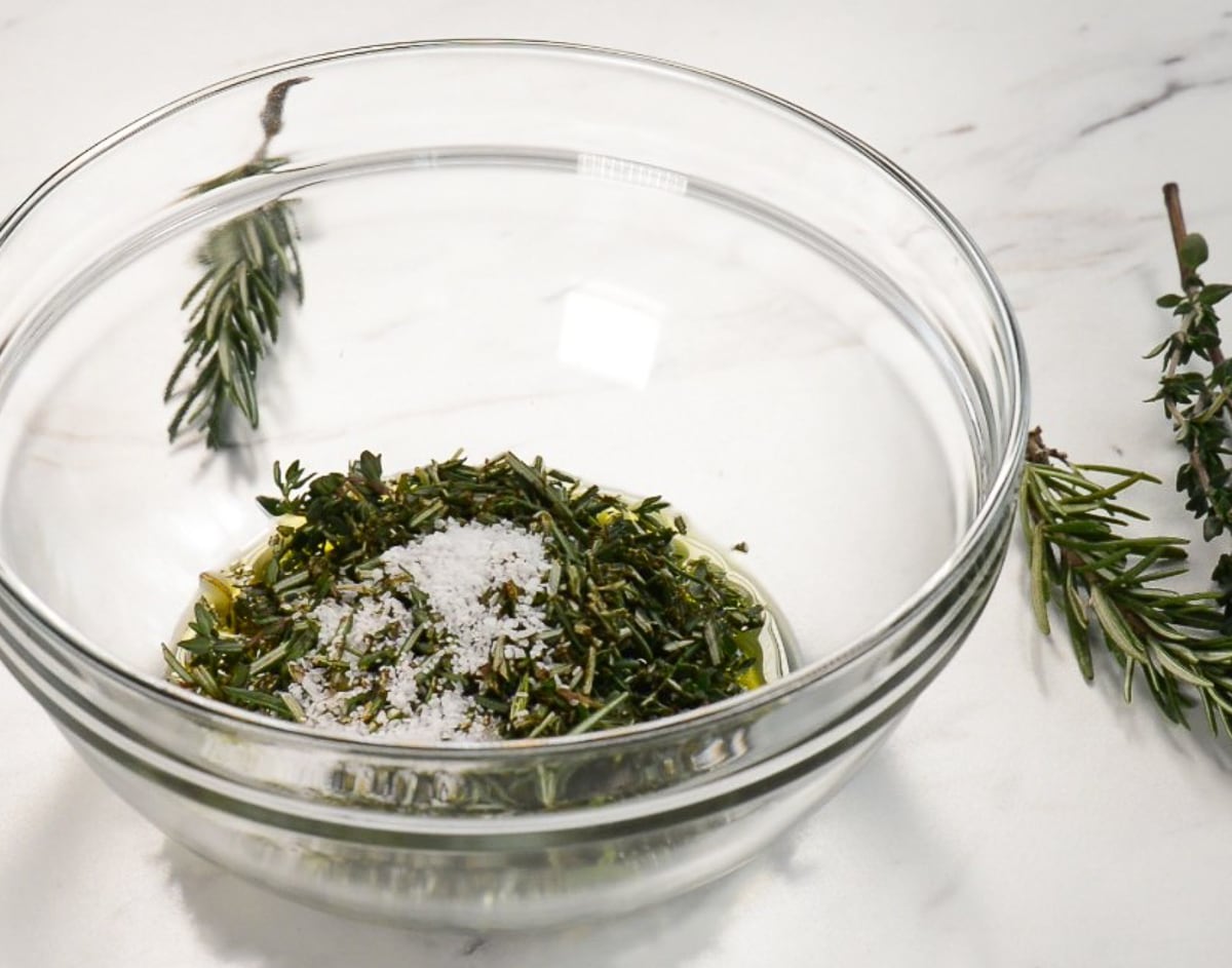 Salt with fresh herbs and olive oil for a prime rib roast.