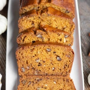 sliced pumpkin bread on white platter