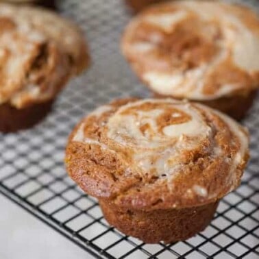 Muffin or cupcake? Its hard to tell with these incredibly moist, super tasty, and slightly naughty Pumpkin Cheesecake Muffins. You will love them!