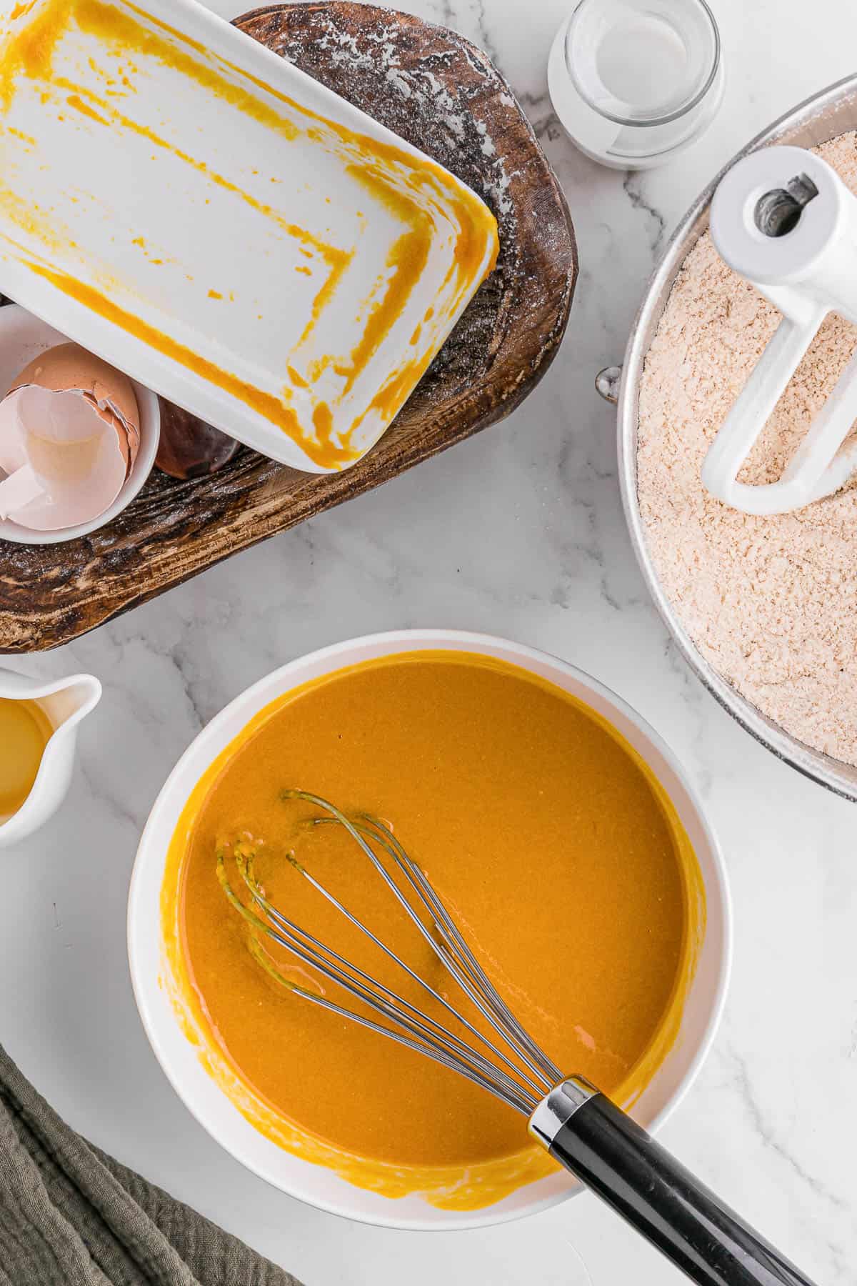 mixing wet ingredients for pumpkin coffee cake recipe.