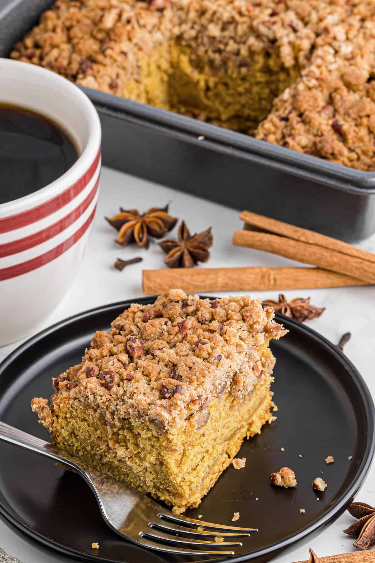 serving of pumpkin coffee cake with cup of coffee.