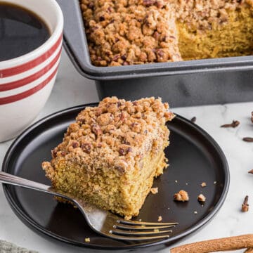 serving of pumpkin coffee cake with cup of coffee.