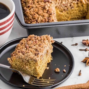serving of pumpkin coffee cake with cup of coffee.