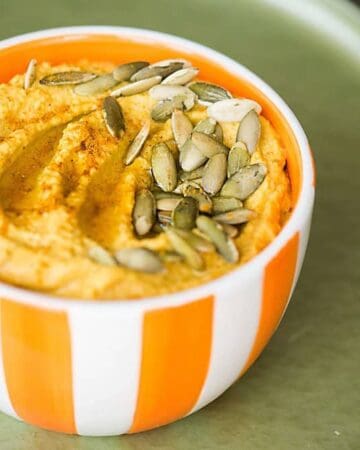 Pumpkin Curry Hummus is a great healthy snack. By adding pumpkin puree and curry powder to this homemade blend you end up with the perfect fall appetizer.