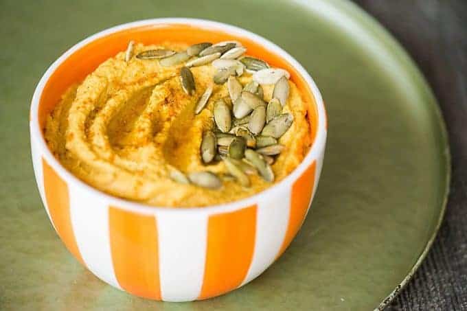 Pumpkin Curry Hummus is a great healthy snack. By adding pumpkin puree and curry powder to this homemade blend you end up with the perfect fall appetizer.