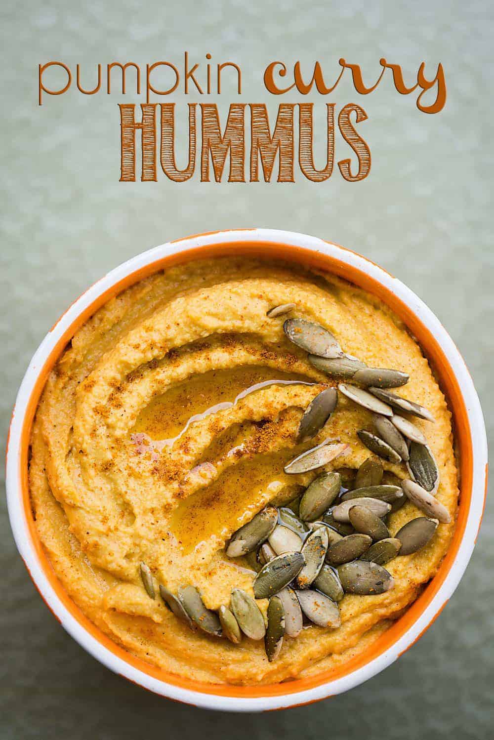 pumpkin curry hummus in a white and orange bowl