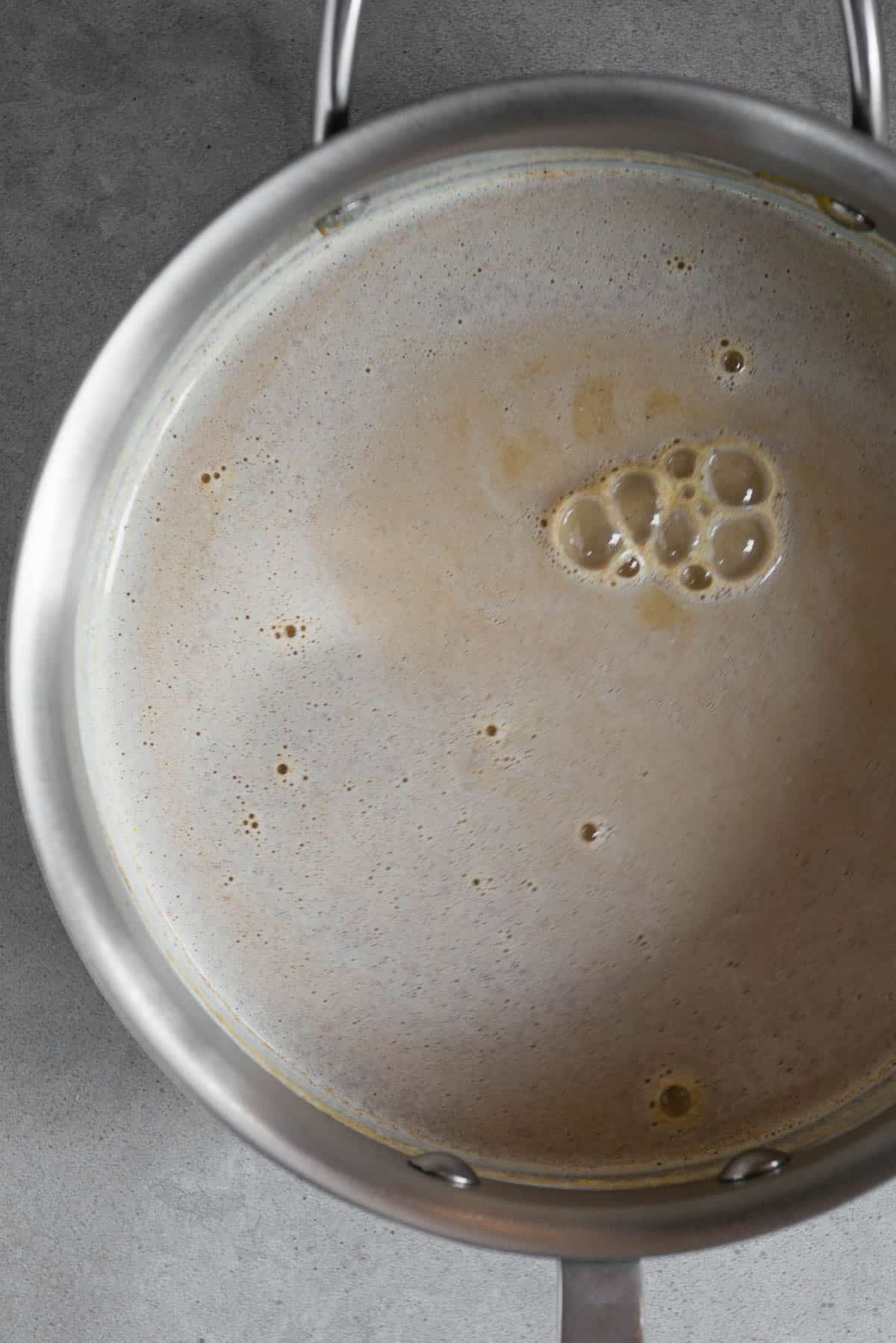 heated milk with cinnamon in pot