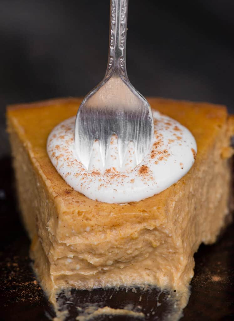slice of pumpkin cheesecake with whipped cream