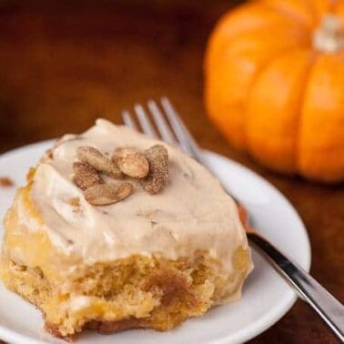 These super soft and delicious homemade from scratch Pumpkin Spice Cinnamon Rolls are made with real pumpkin and have an added pumpkin seed crunch.
