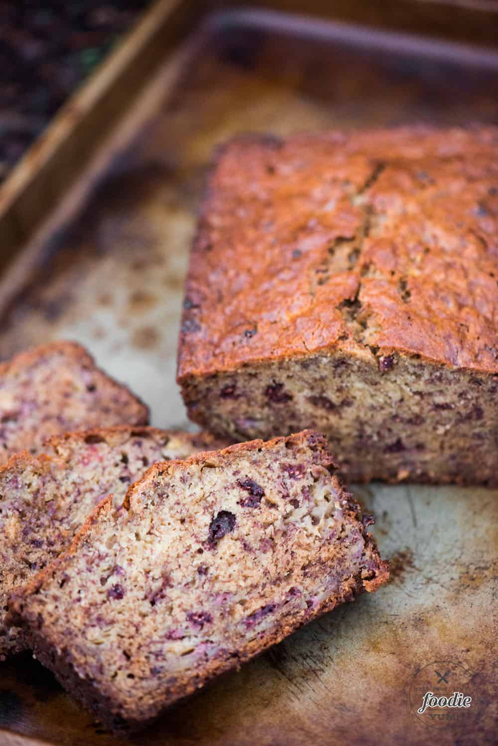 slices of homemade banana bread with raspberries