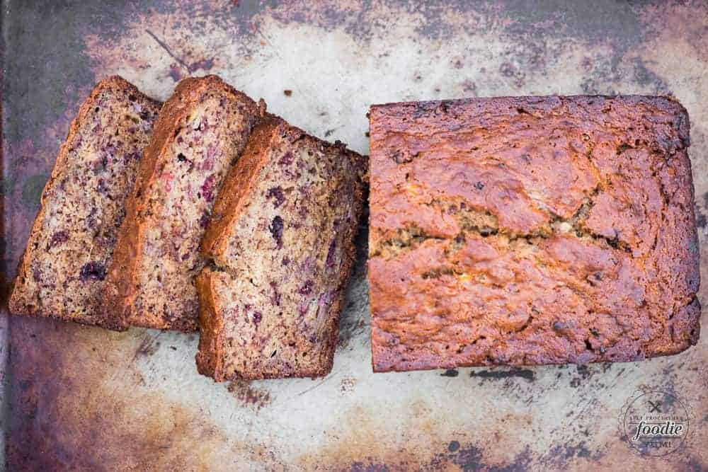 Moist banana bread sliced loaf made with freeze dried raspberries