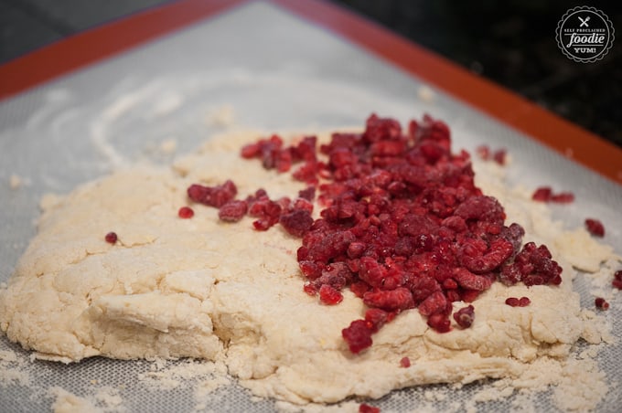 frozen raspberries on top of scone dough