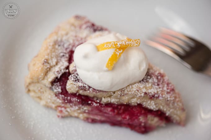 A close up of a raspberry lemon buttermilk scone