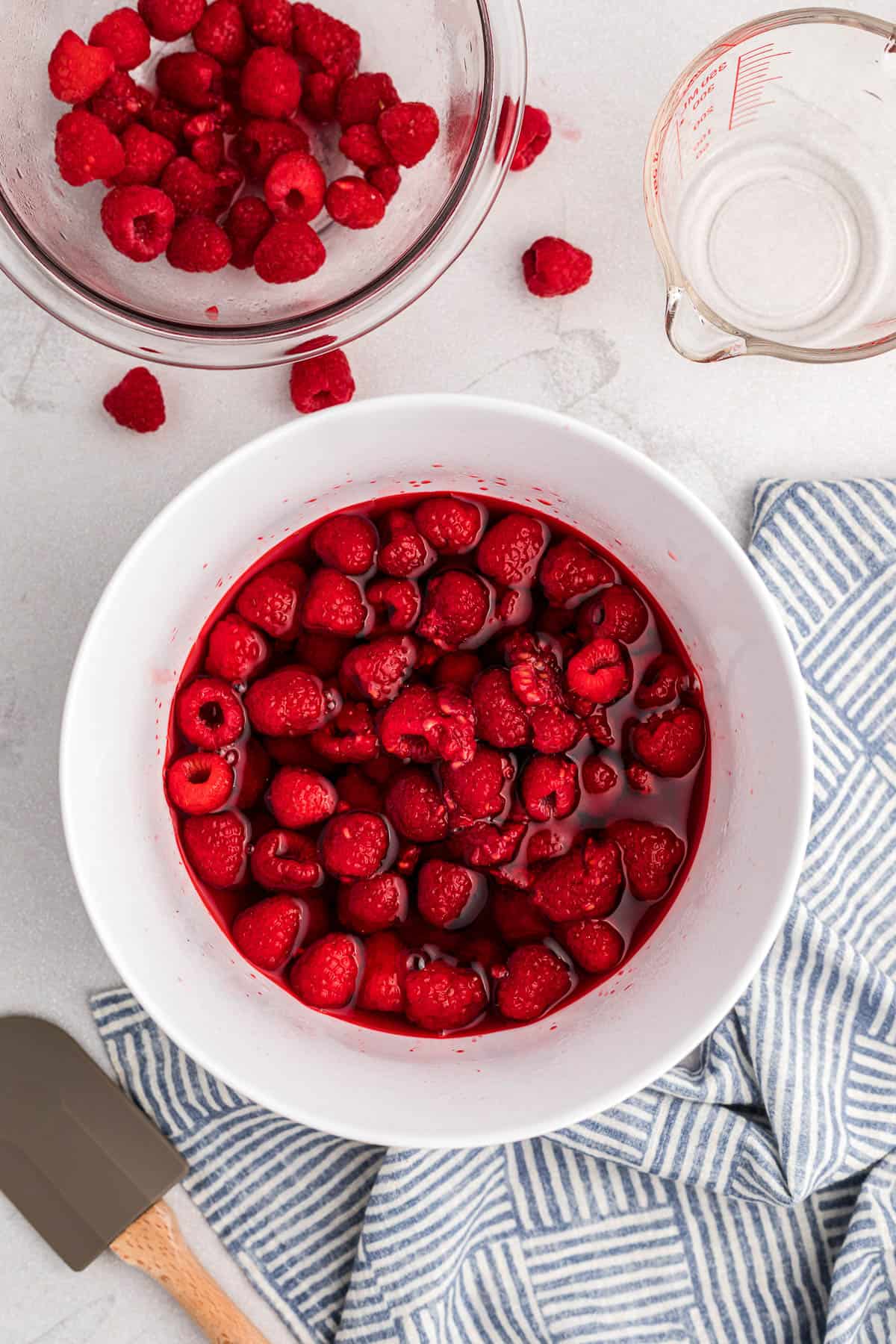 bowl of fresh red raspberries in liquid raspberry Jello.