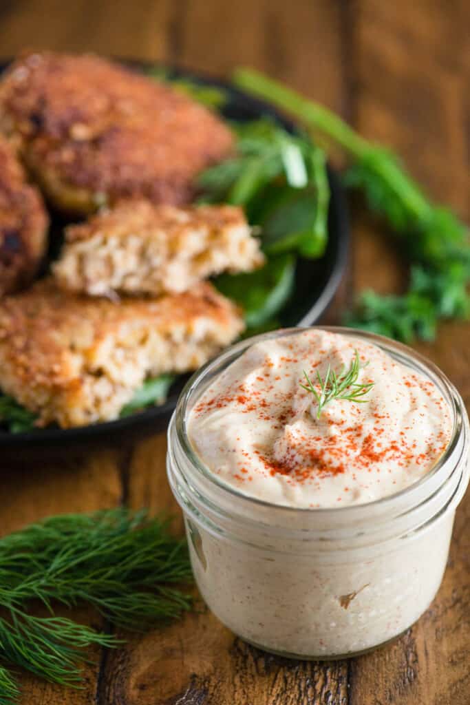 homemade remoulade sauce in mason jar served with crab cakes.
