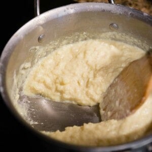stirring rice pudding in pan on stove